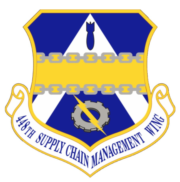 Logo des 48. Versorgungsgeschwader mit einem blauen Schild mit einem weißen Stern und einem weißen Banner mit der Aufschrift "Versorgungsgeschwader" in blau, alles in weiß mit schwarzem Text umrandet.