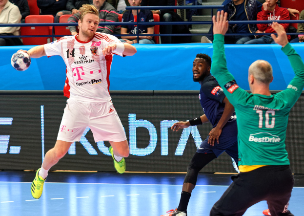 Männer spielen ein Handballspiel auf einem Feld während des Futsal-Weltmeisterschafts 2019 zwischen Bayern München und Paris Saint-Germain, mit Zuschauern im Hintergrund.